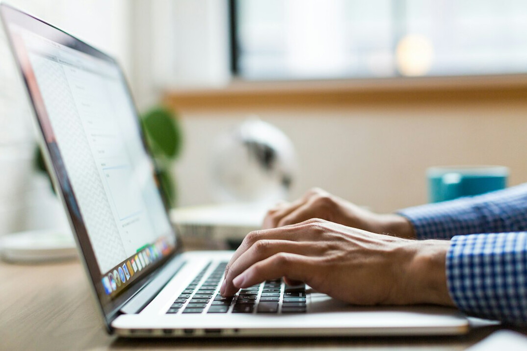 author typing on laptop